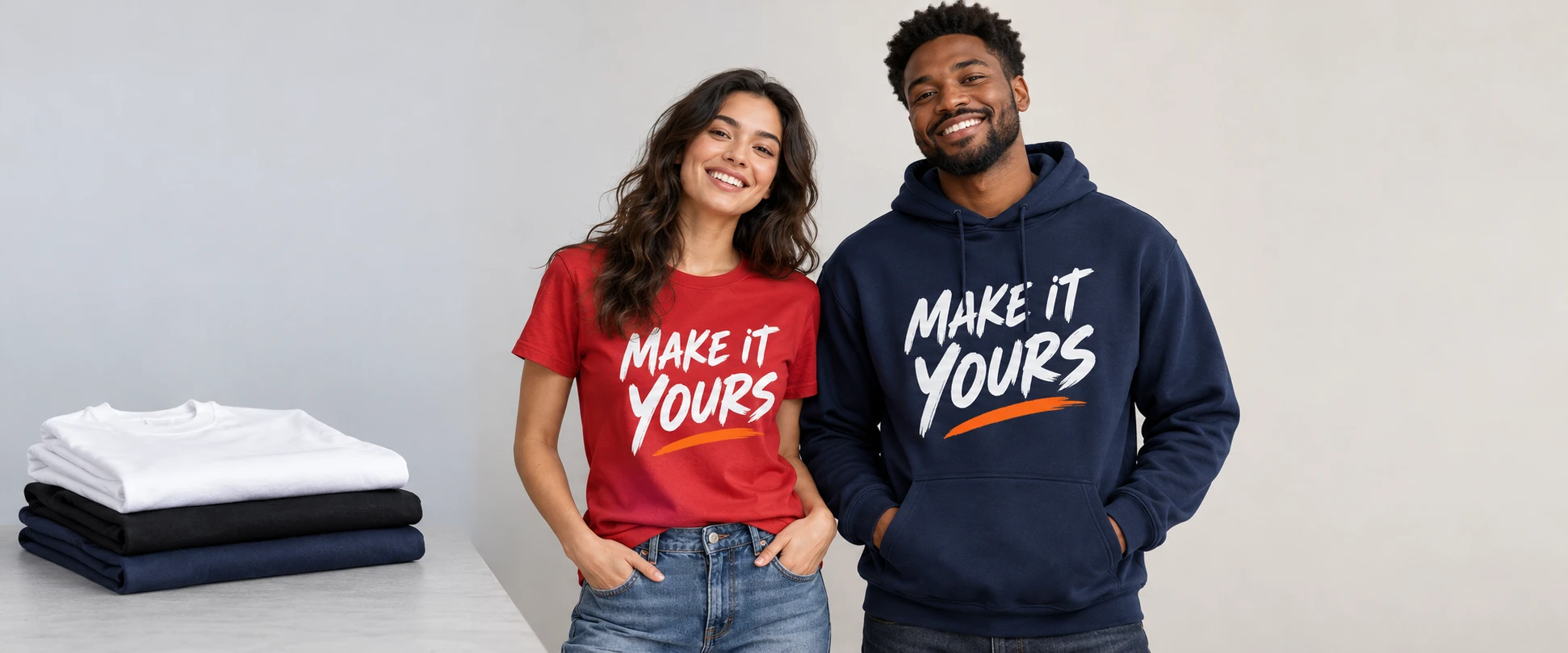 Folded blank tees and colorful custom T-shirts and hoodies with MAKE IT YOURS artwork